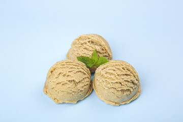 Obraz premium Peanut Butter Ice Cream Scoops with Mint Garnish