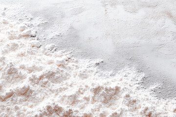 White powder spread across a surface with a natural gradient in texture and color during daylight hours