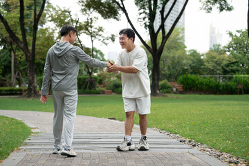 Happy meeting Asia mature with Asia young man in the park