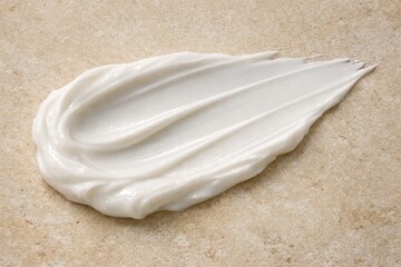 Cream Swatch: Close-up of a smooth, textured cream swatch, showcasing the product's luxurious consistency and radiant appearance. The cream spreads elegantly across the surface.