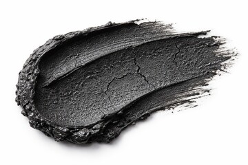 Cosmetic Swatch: An artistic display showcases a smear of dark charcoal cosmetic product, embodying both texture and visual appeal, ideal for beauty and skincare concepts.