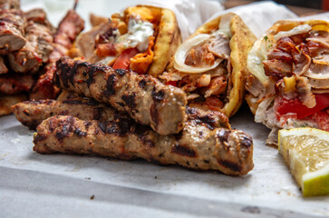 Gyro sliced meat pita bread wraps and kebab pieces, traditional street food, closeup