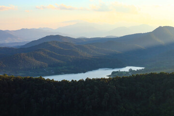 Overlapping mountain landscape in the morning with clouds and fog on the mountain surface.	
