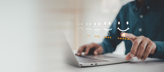Excellent Service Feedback with Five Stars , Man is using a laptop, pointing at a virtual happy face and five-star rating icon on a customer satisfaction survey interface.