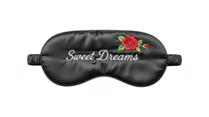 Black satin sleep mask with sweet dreams text and red rose design isolated on transparent background