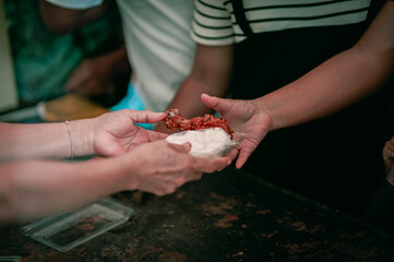 The hand of a beggar received food from a compassionate person, Concept of sharing