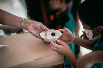 The hands of the hungry are asking for food from the donor,Out to the Homeless and Hungry