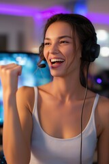 Naklejka premium Young caucasian female gamer celebrating victory in gaming setup with headset