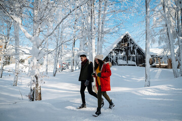 Couple walking together on romantic winter date in snowy nature