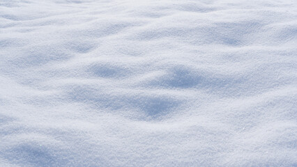 Winter background with snow-covered wavy uneven ground surface,