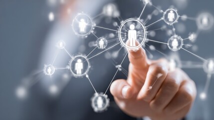 Close-up of hand touching a glowing interconnected network of human figures. Soft focus background. Represents connection