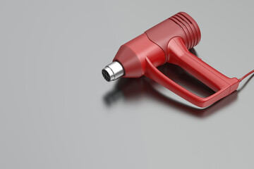 Red industrial electric heat gun on metal table