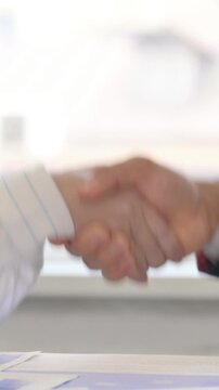 Close up of Business People Shaking Hand at Work, vertical video