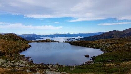 Panoramic view of a tranquil alpine lake, cradled by a rugged natural environment, with a dramatic cloudscape above distant mountains, embodying peaceful wilderness