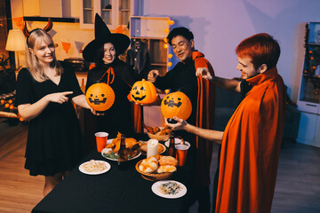 Friends enjoying a Halloween party at a bar making a toast