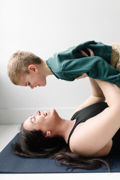 Mother and son playing and laughing together exercising