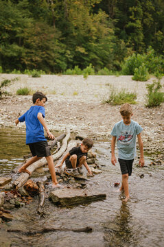 Three boys exploring rocks and water at Turkey Run State Park