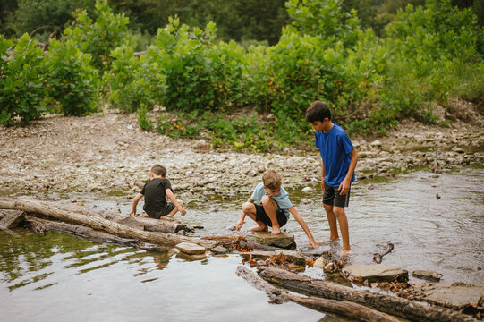 Three boys explore creekside rocks at Turkey Run State Park