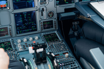 Detail view of aircraft cockpit control panel and flight data screens