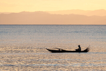 Malagasy fisherman in a traditional canoe, Madagascar.