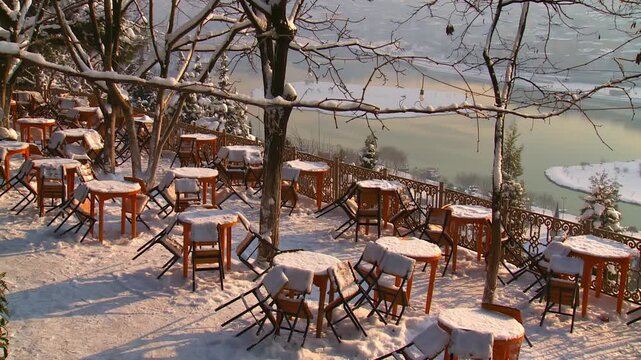Snow Covered Tables and Chairs With the Golden Horn in the Background on a Sunny Winter Day