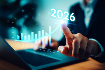 Digital strategy and future economic trend in 2026. Businessman touching virtual interface with rising financial chart and arrow, representing business growth, investment success, data analysis.