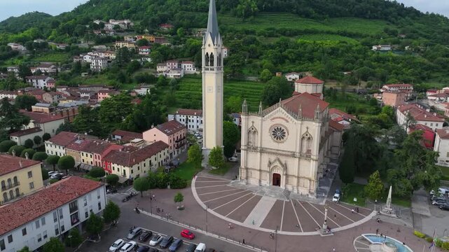slow rising aerial of Duomo di Santa Maria e San Vitale, Piazza Marconi Guglielmo in Montecchio Maggiore, Italy