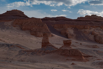 The natural rock sculpture "Mongolian Sphinx" in the Khermen Tsav canyon. Wind erosion carved a red sandstone profile strikingly reminiscent of a human face gazing into the Gobi Desert.