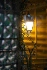 Indoor lamp behind windows.