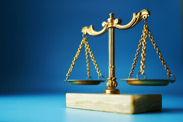 close up of libra scale  against blue background