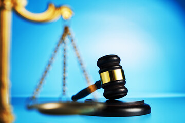 libra scale and gavel hammer on blue background focus on background