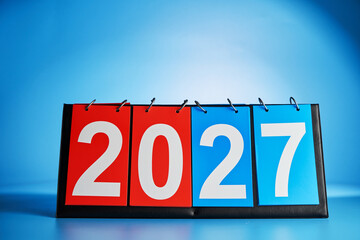 manual paper flipping paper score board against blue bckground