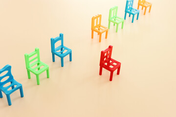 concept image of a row of small chairs and one standing out