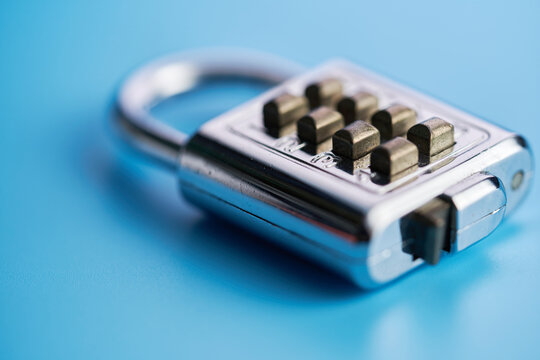 silver colored numberic lock against blue background