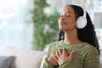 Black woman doing guided breathing exercises at home