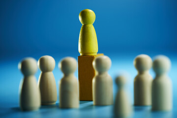Symbolic leadership concept with leader elevated above the crowd.
