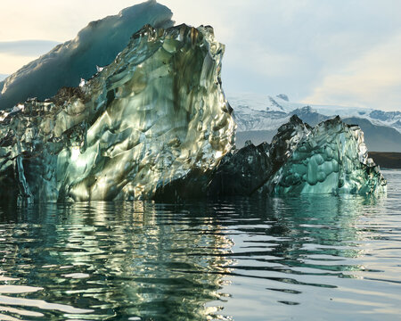 Reflecting Iceberg in Glacial Lagoon in Dramatic Light