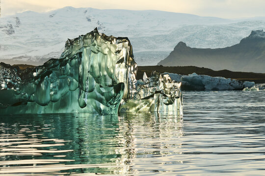 Reflecting Iceberg in Glacial Lagoon in Dramatic Light