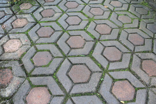 Geometric hexagon sidewalk tiles forming repeating urban pattern - Powered by Adobe