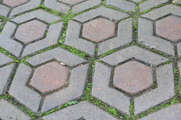 Old hexagonal pavement texture with worn concrete surface
