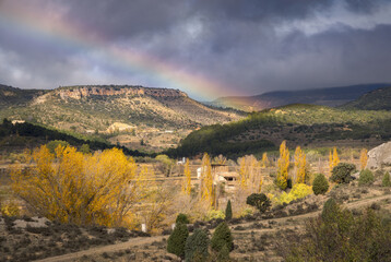 Breathtaking rainbow arches over Teruel's autumn landscape, Spain