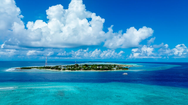 The aerial view of Small tropical island in the ocean, Maldives.	