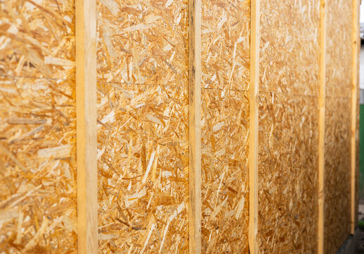 Sheathing of the house with OSB panels. The walls of the frame house are sheathed with OSB boards for further finishing. Construction of frame houses and their cladding.