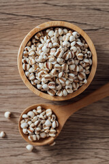Whole Grains in Bowls and Spoon on Wooden Table Surface
