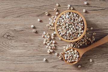 Raw Natural Grains in Wooden Bowl on Wooden Surface Background