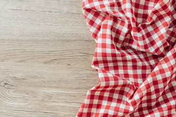 Red and White Checkered Fabric on Rustic Wooden Surface Background