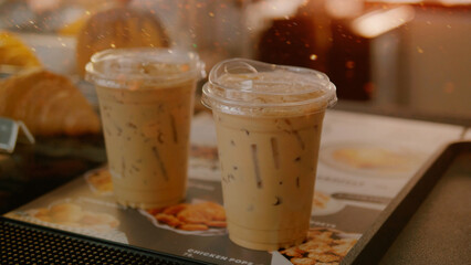 An iced coffee, drinking freshly brewed coffee in the morning, and replenishing the body's caffeine levels.