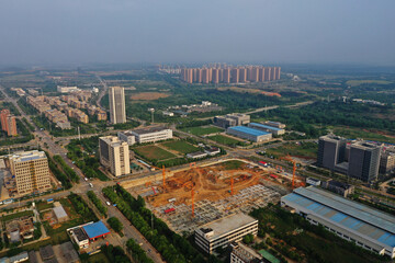 Fototapeta premium Wuhan Industrial Construction Site Aerial View with Cranes and Urban Landscape