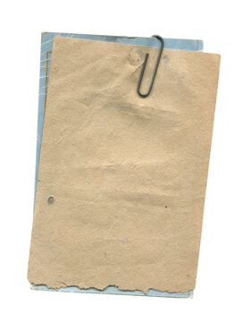 Stack of old paper tags clipped together with a metal paper clip  isolated on white