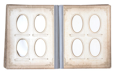Open vintage photo album with oval decorative frames and empty picture windows on aged paper pages